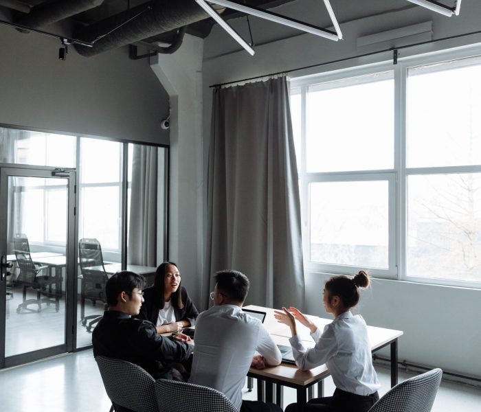 pexels-photo-7652187-7652187 A group of professionals engaged in a business meeting inside a contemporary office setting.